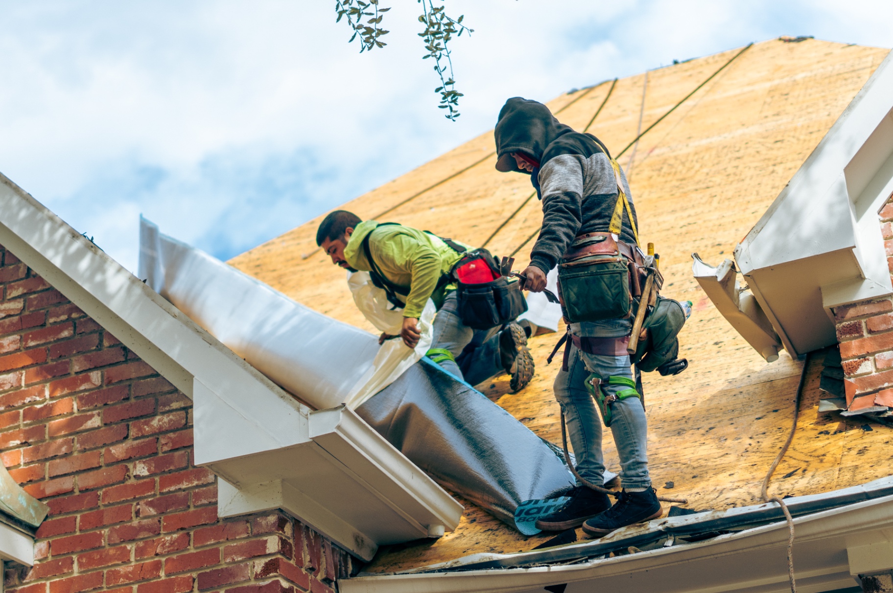 Stonebriar crew installing underlayment on a re-decked roof
